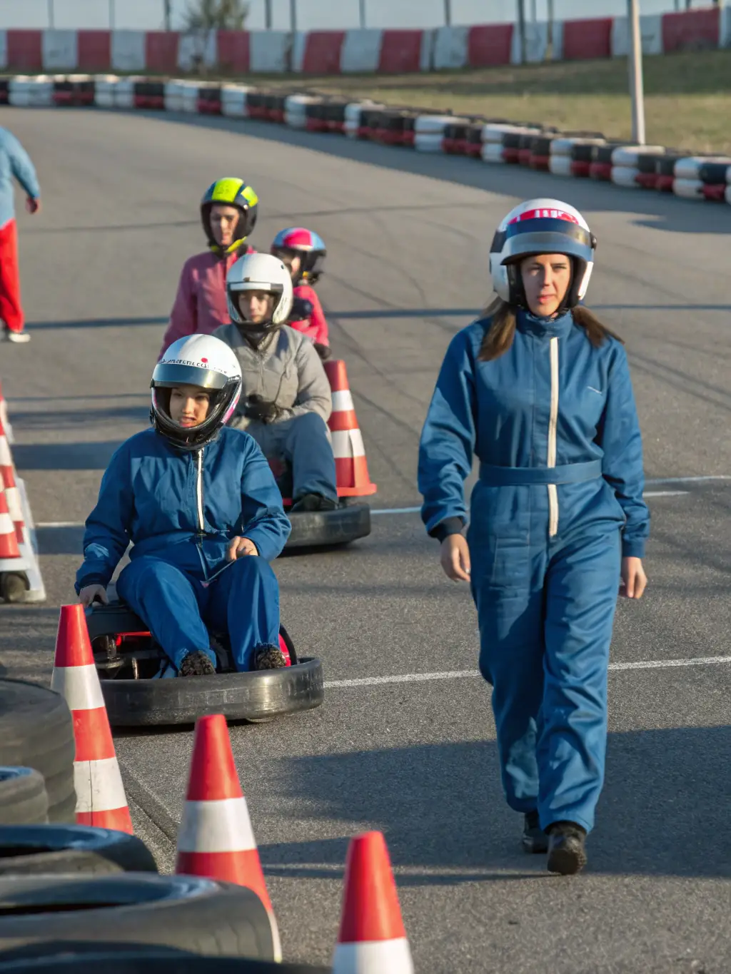 A photograph capturing a group of young motorsport enthusiasts participating in a training session, showcasing their engagement and enthusiasm.
